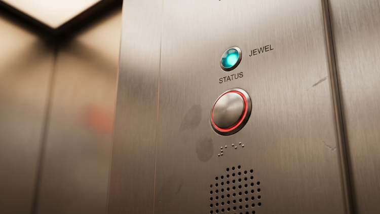 Elevator emergency call button glowing red after being pressed.